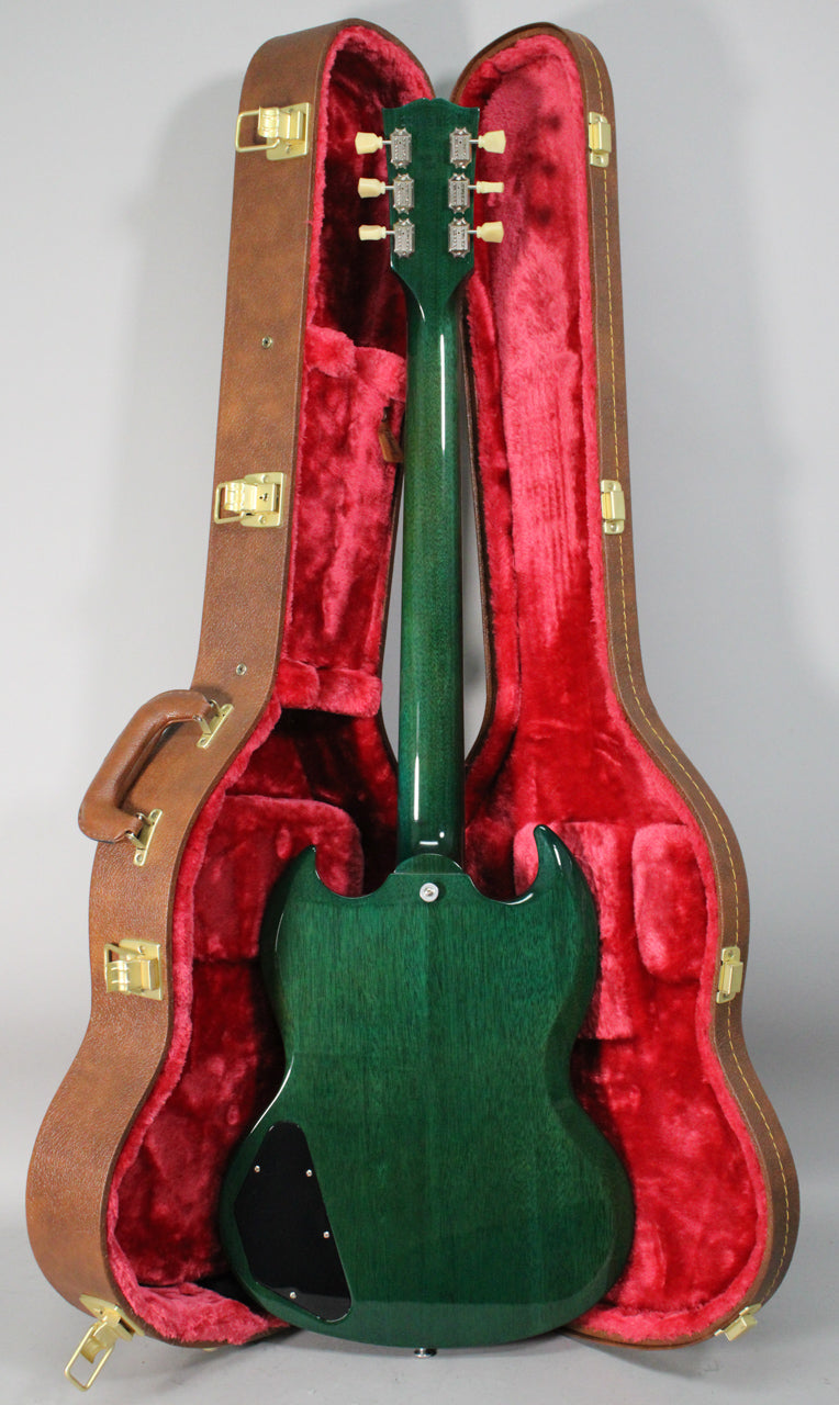 The translucent teal SG is shown from the back, resting in its brown hardshell case with red plush lining.