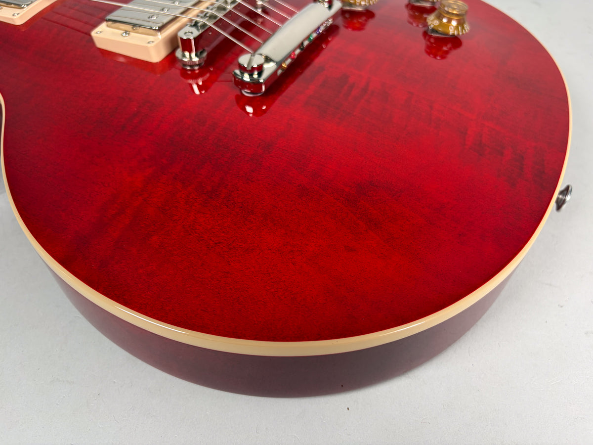 Close-up of the cherry red flame top body, showing the lower bout, cream binding, and two gold speed knobs.