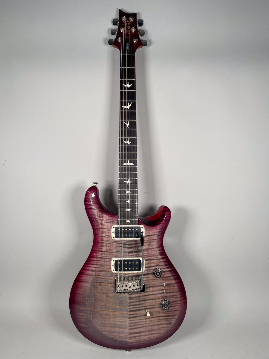 Full-length view of a purple burst electric guitar with a flamed maple top, two humbuckers, and bird inlays on the fretboard.