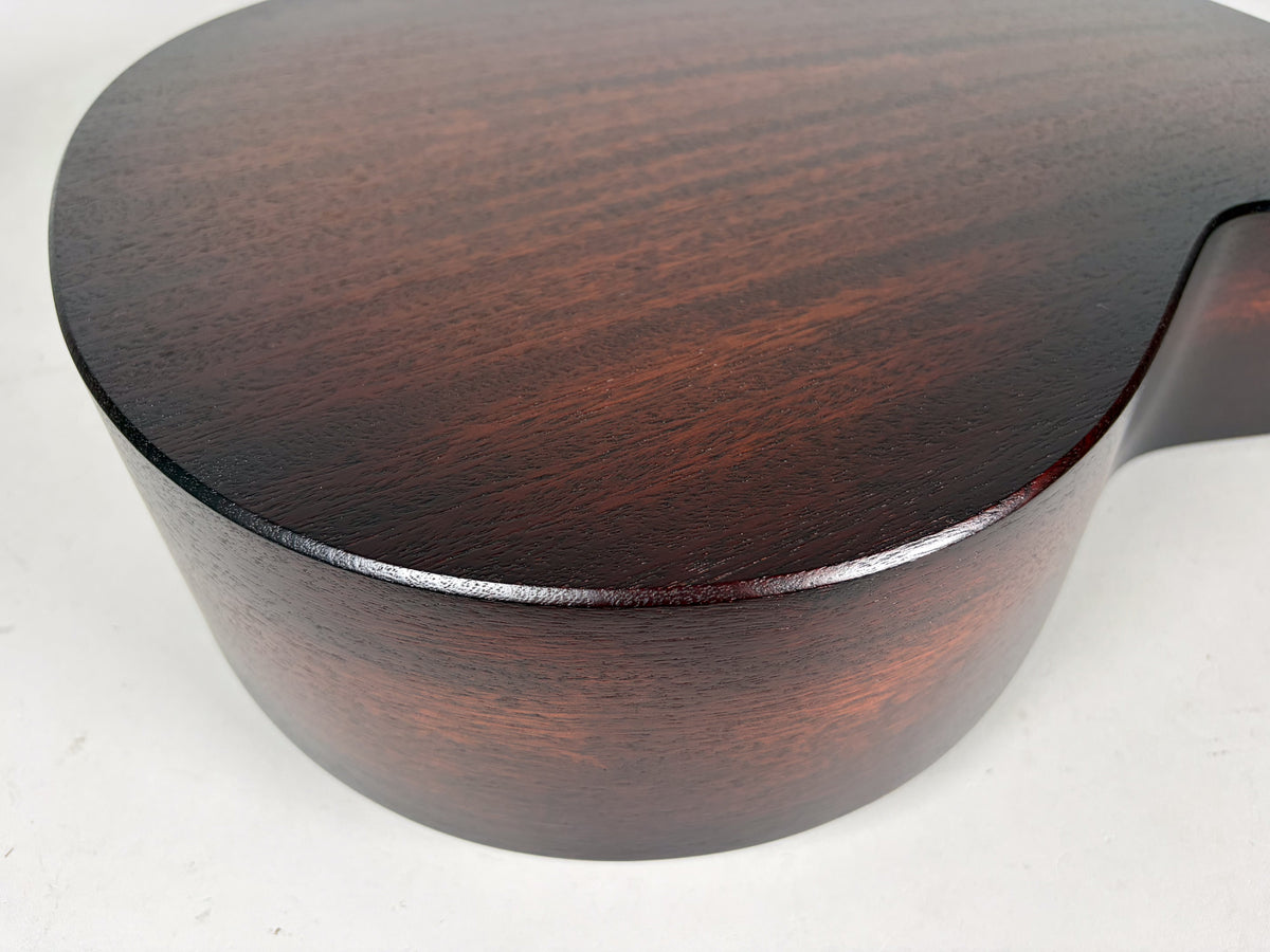 The lower bout of the guitar, showing the dark sunburst finish with visible wood grain on the top and side.