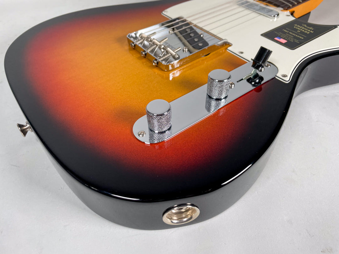 Close-up of the guitar's lower bout, showing the sunburst finish, chrome control plate with two knurled knobs, and output jack.