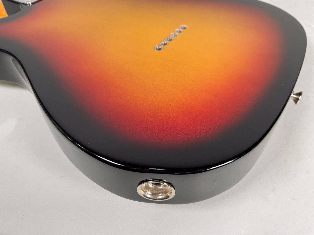 The back of the sunburst Telecaster body, showing the string-through-body ferrules and the chrome output jack on the lower bout.