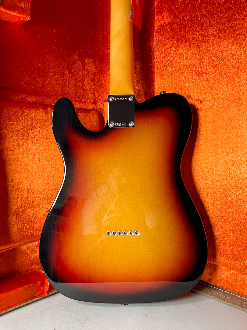 The back of a sunburst Telecaster body, showing the neck plate, string-through-body ferrules, and a maple neck.