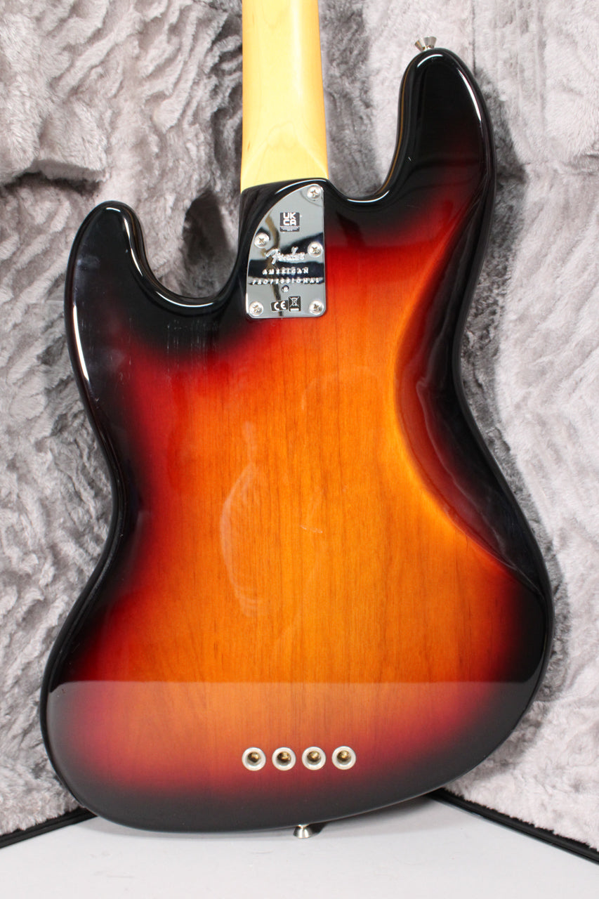 The back of a 3-color sunburst bass guitar, showing the neck plate, light wood neck, and four gold string ferrules.