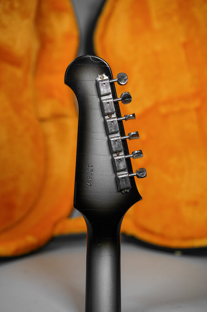 Rear view of the guitar's dark silverburst headstock and neck, showing six aged nickel tuners and light finish checking.