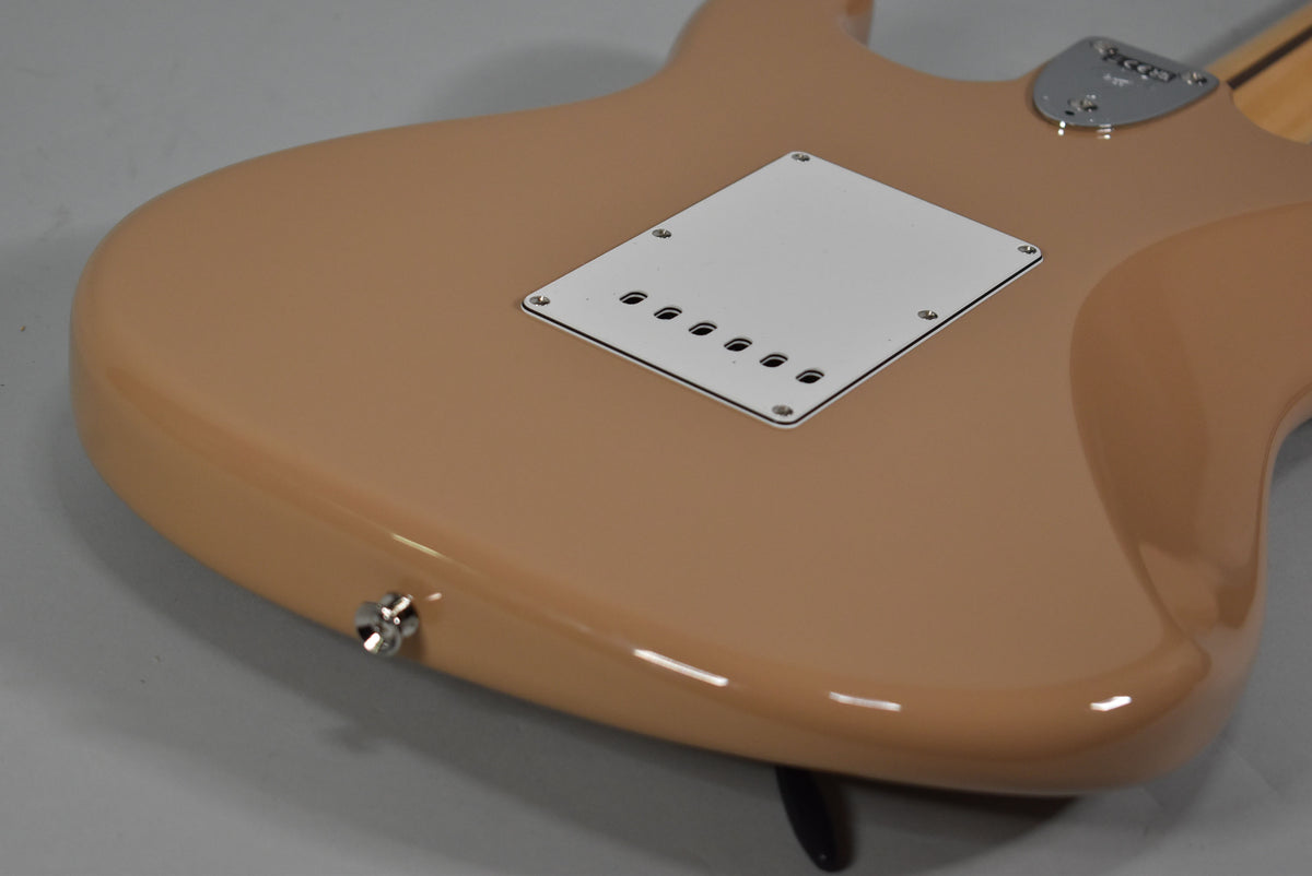 The Sahara Taupe Stratocaster's back shows a white tremolo cover, chrome neck plate, and strap button, all in excellent condition.