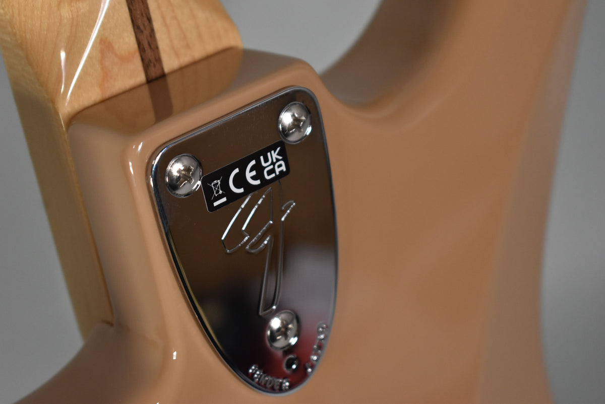 Close-up of the Sahara Taupe guitar's body and neck joint, showing the chrome neck plate with four screws and a glossy finish.