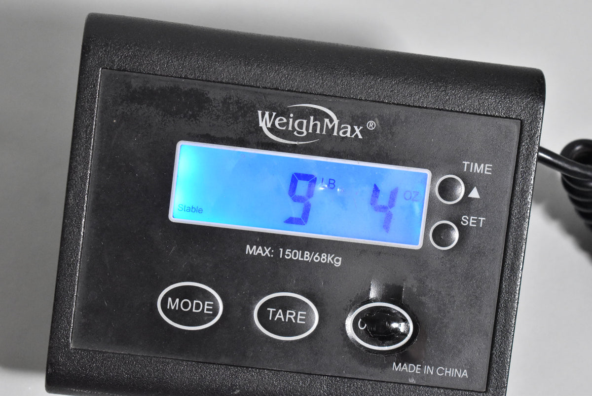 A black digital scale displays "9 LB. 4 OZ." in blue, with "Stable" and "WeighMax" visible.
