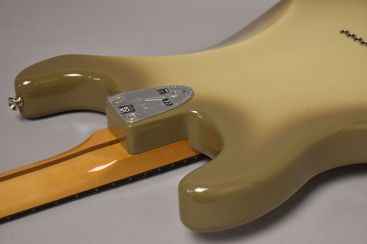 The guitar's Antigua finish is visible from the back, showing the neck plate, strap button, and six string-through-body ferrules.