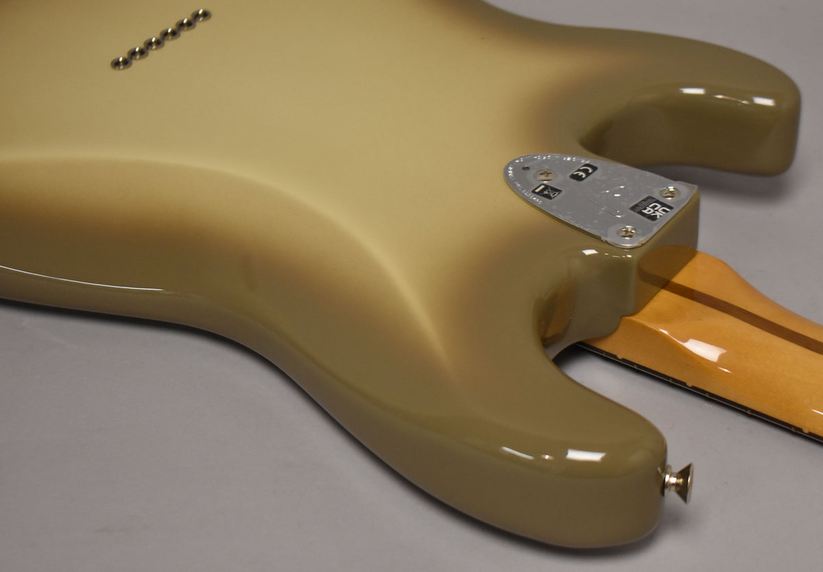 The guitar's back, showing the Antigua finish, neck plate, six string-through-body ferrules, and a gold strap button.