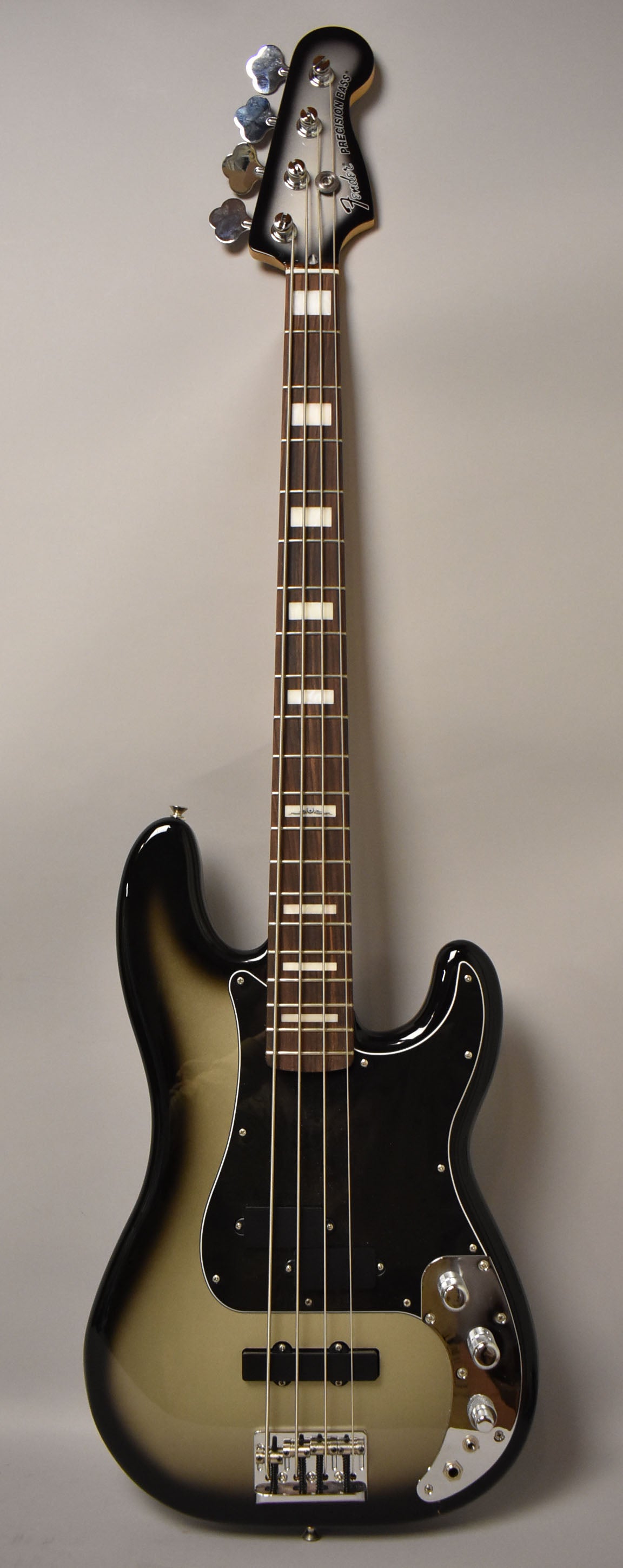 Full front view of a silverburst bass with a dark fretboard, rectangular block inlays, and chrome hardware.