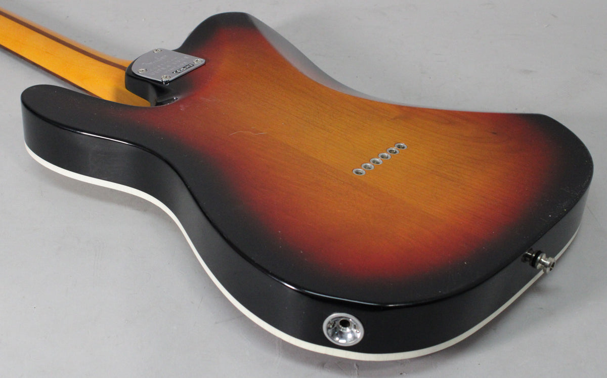 Back of a 3-color sunburst Telecaster-style guitar, showing the neck joint, string-through-body ferrules, and output jack.