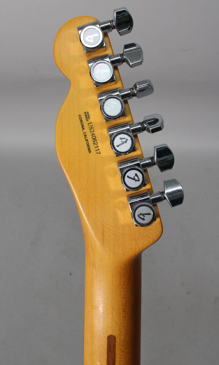 Close-up of the guitar's headstock and upper neck, showing six chrome tuners with pearloid buttons and fine lacquer checking.