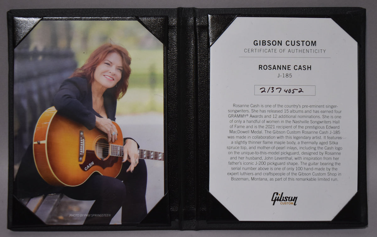 An open black folder displays a photo of Rosanne Cash with a sunburst acoustic guitar, and a Gibson Custom Certificate of Authenticity.