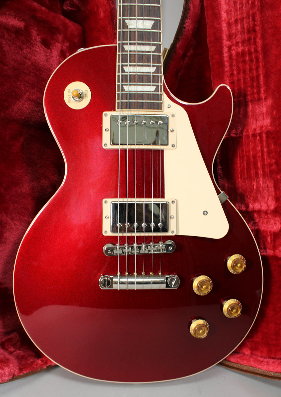 Sparkling burgundy Les Paul body, framed from the neck joint to the bottom, with cream binding, pickguard, and gold top hat knobs.