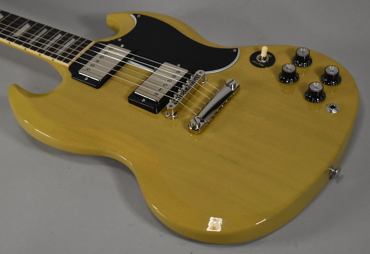 The TV yellow SG body is angled from the neck, showing the black pickguard, two humbuckers, chrome hardware, and four black knobs.
