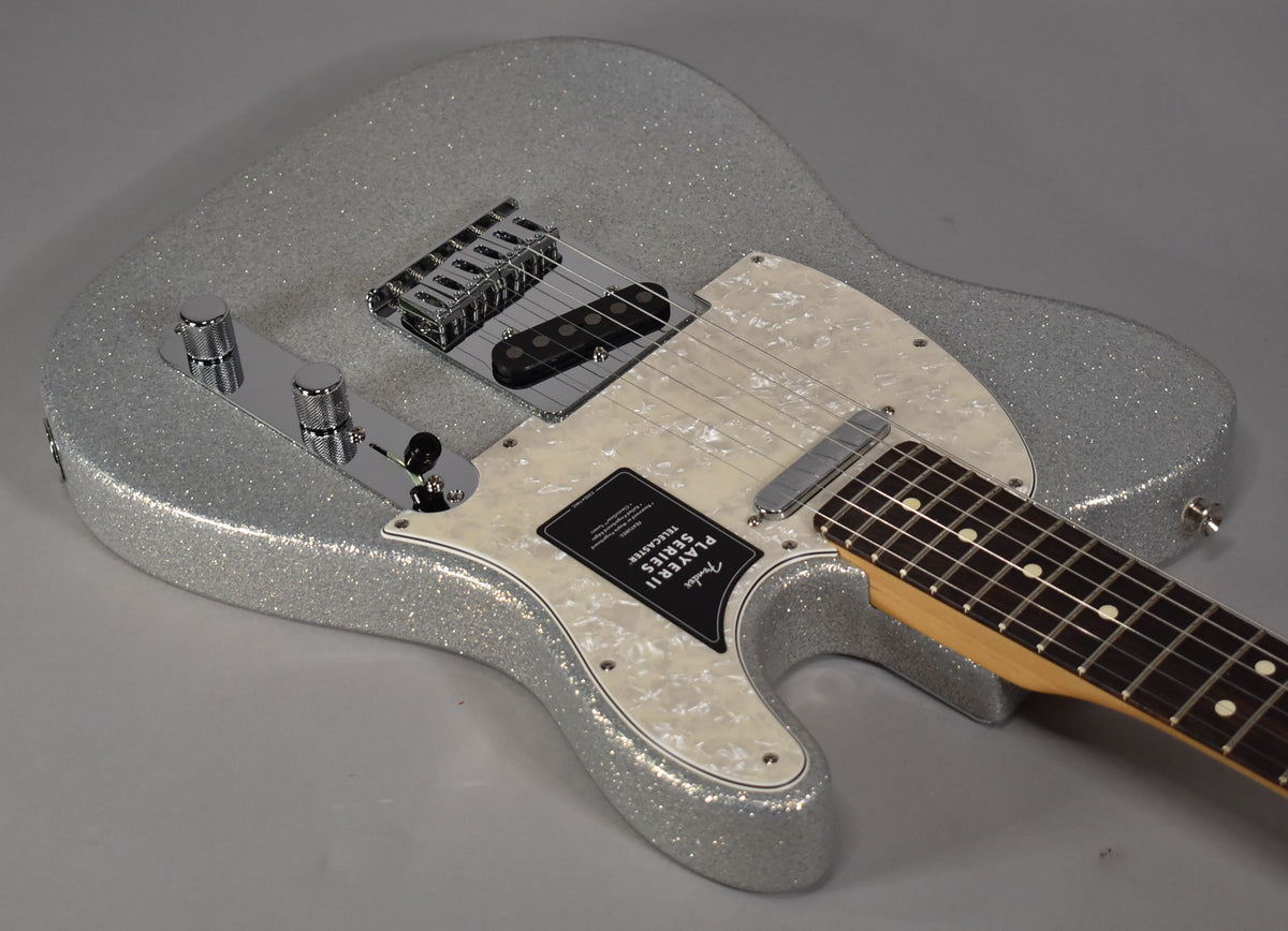 Sparkling silver Telecaster body with a pearloid pickguard, chrome hardware, and a dark fretboard with light dot inlays.