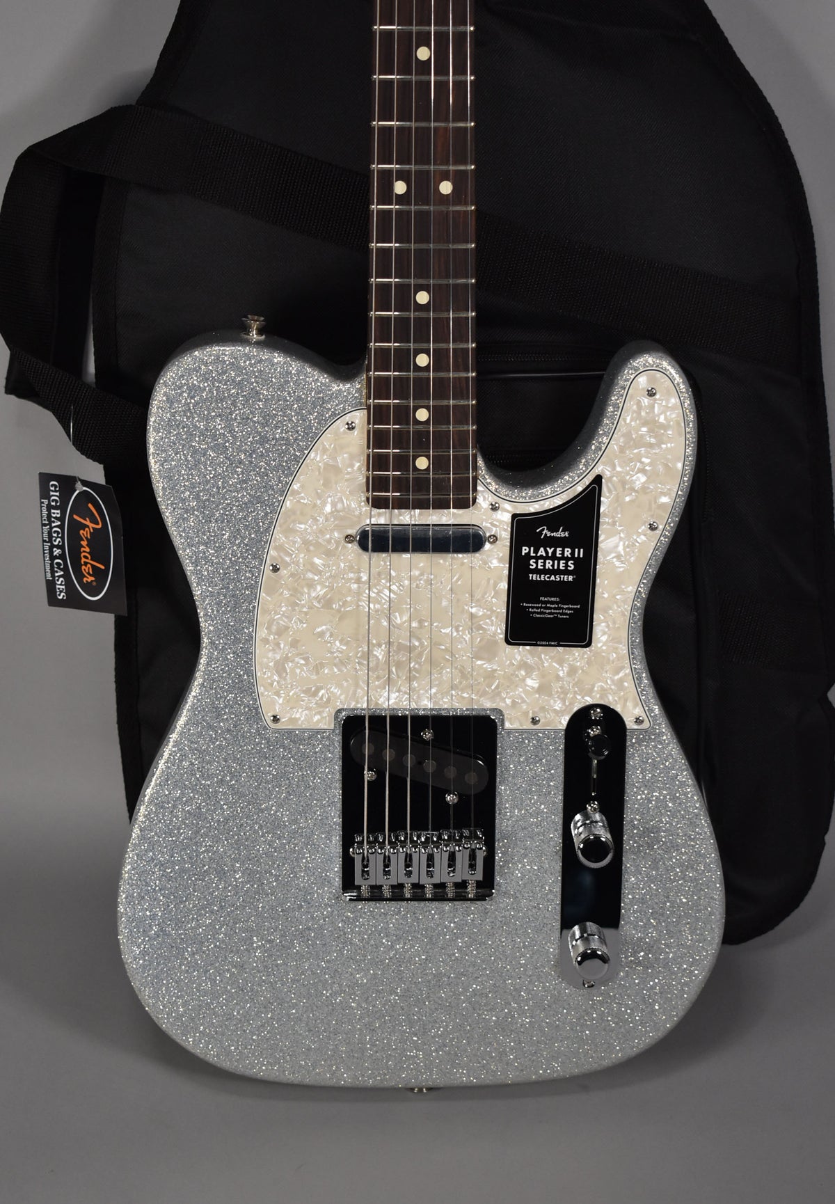 Full front view of a silver sparkle Telecaster with a pearloid pickguard, black bridge pickup, and chrome hardware.