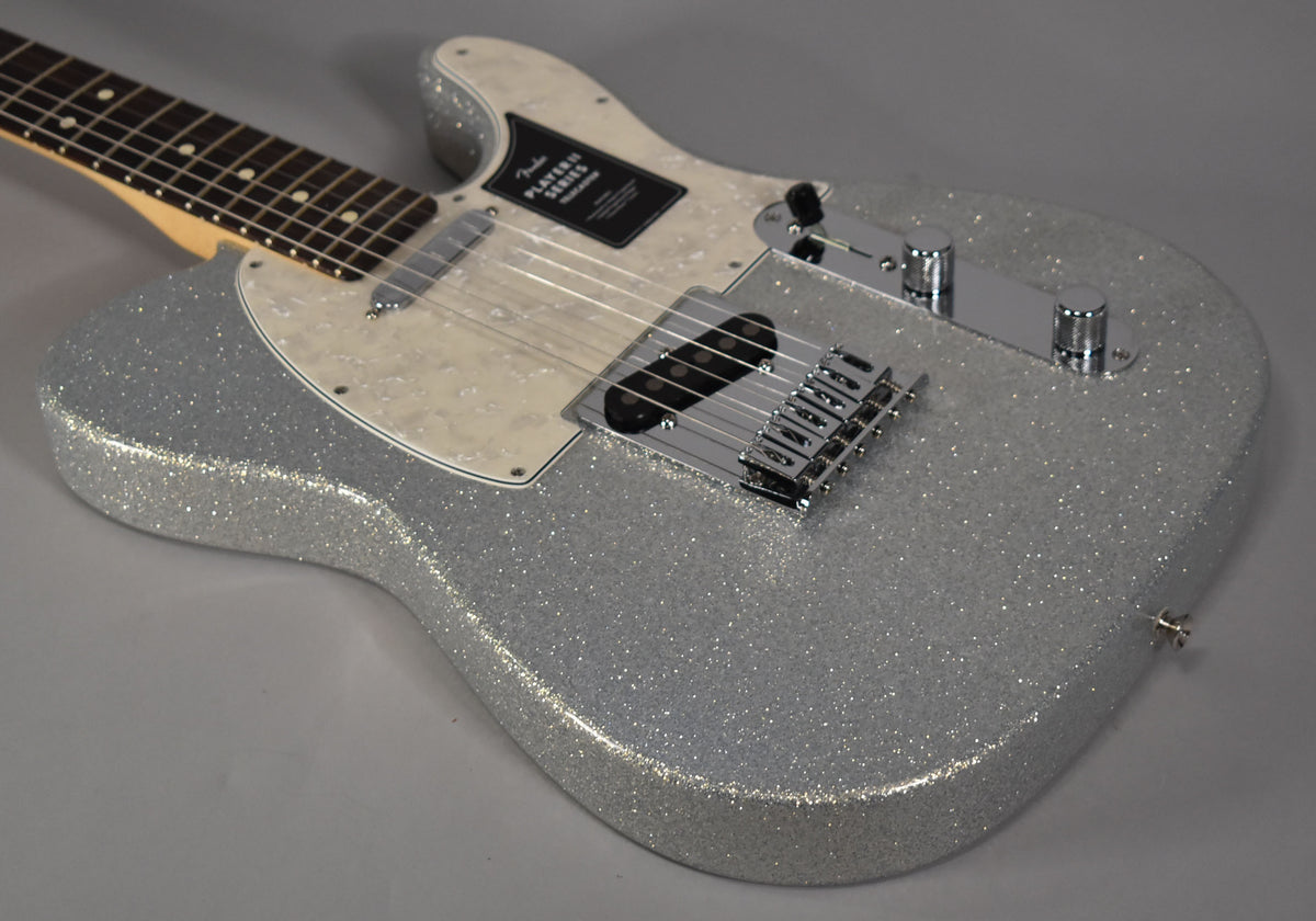 Silver sparkle Telecaster body, angled from the neck to the lower bout, with a pearloid pickguard and chrome hardware.