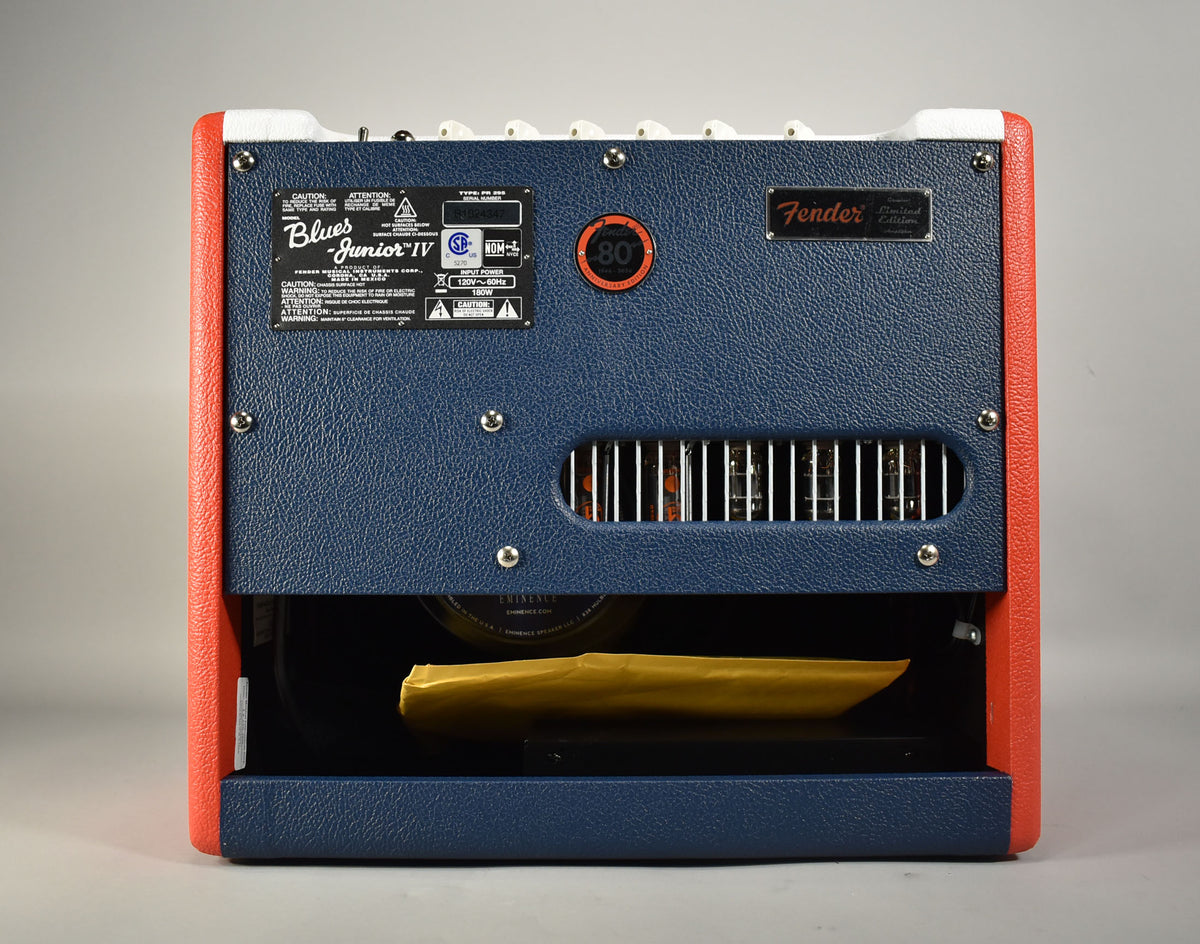 Rear view of the amp, showing its dark blue back panel, orange sides, and white top panel; tubes are visible through a vent.