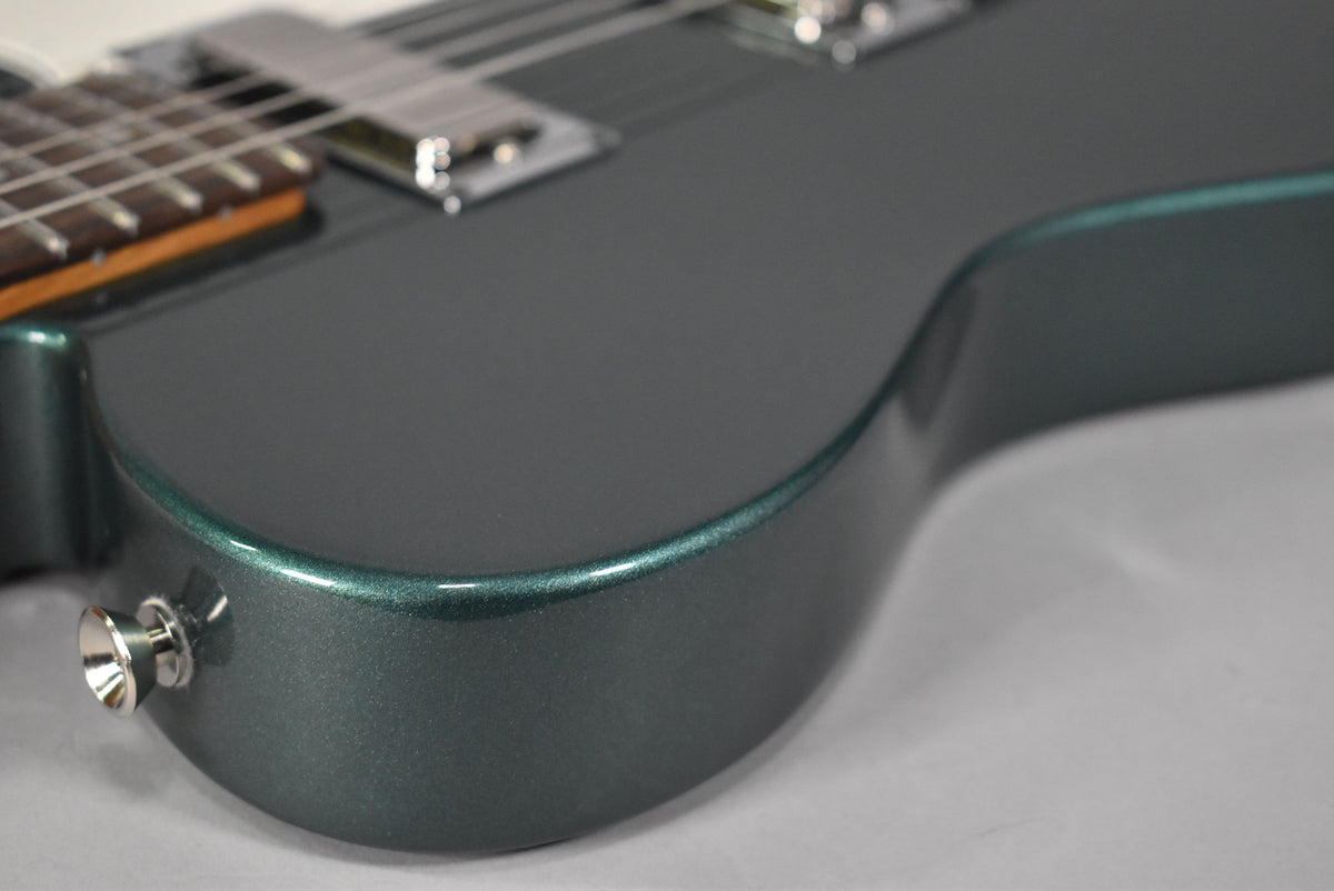 Close-up of the Sherwood Green metallic body, showing the lower bout, strap button, and part of the neck and bridge pickup.