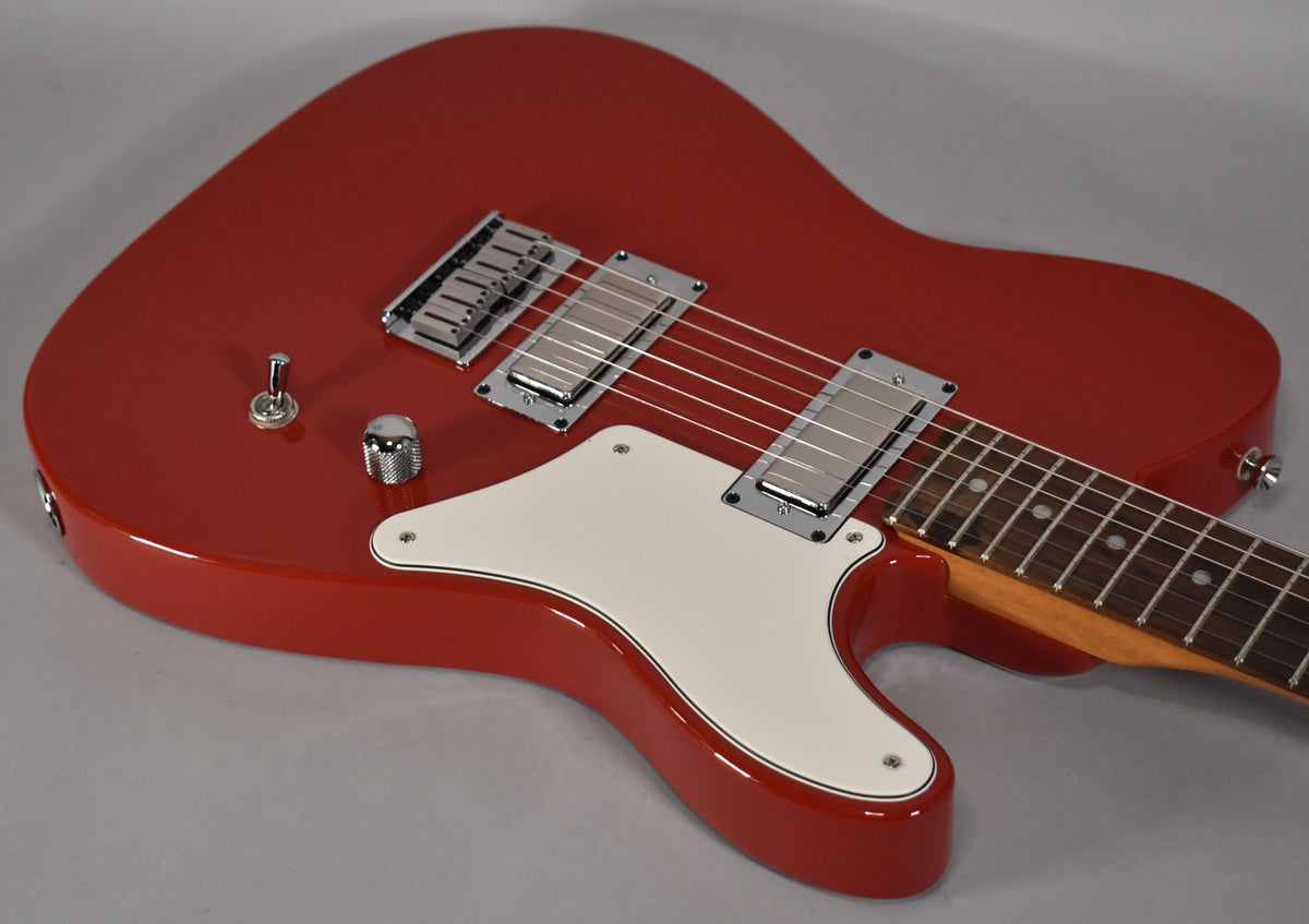 Cherry red guitar body with a white pickguard, two chrome humbuckers, a chrome bridge, and two chrome knobs.
