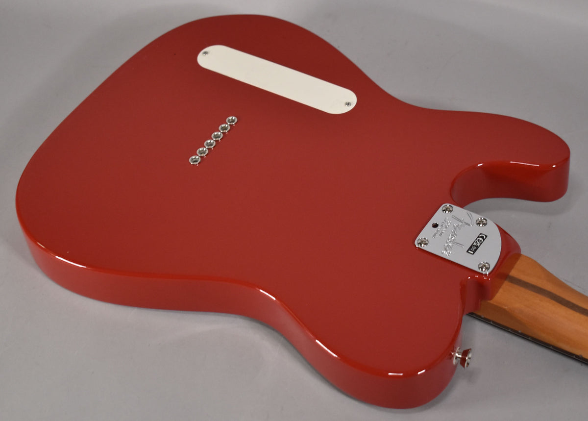 The back of a glossy red Telecaster body, angled from the lower bout, showing string-through ferrules and a chrome neck plate.