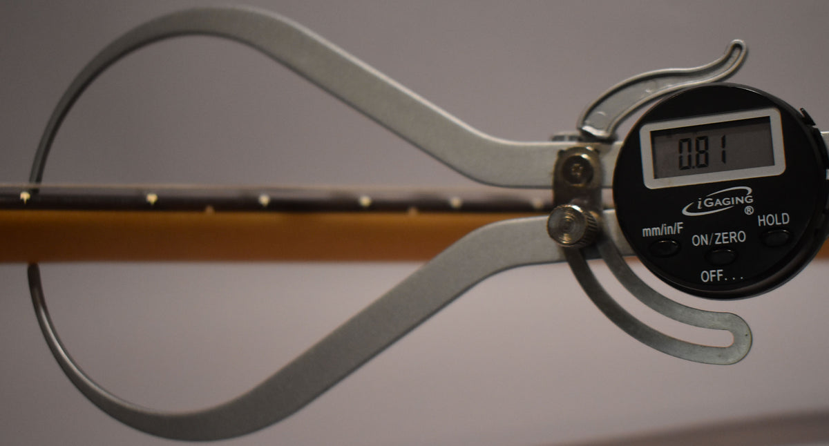A digital caliper measures the fret height on the dark fretboard of the Birch Green Jazzmaster, showing 0.81mm.