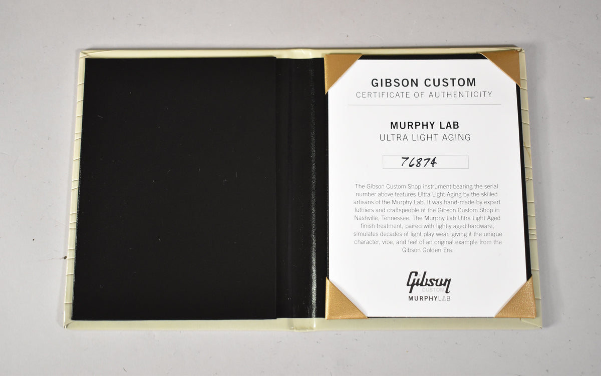Open cream-colored certificate folder with a black interior, holding a white "Certificate of Authenticity" document.