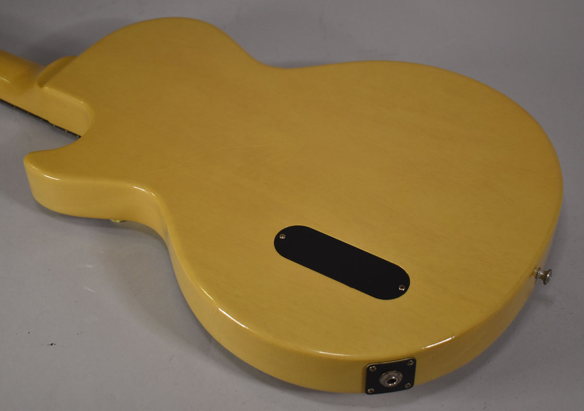 The TV Yellow guitar's back shows light aging, a black control cavity cover, and a chrome output jack and strap button.