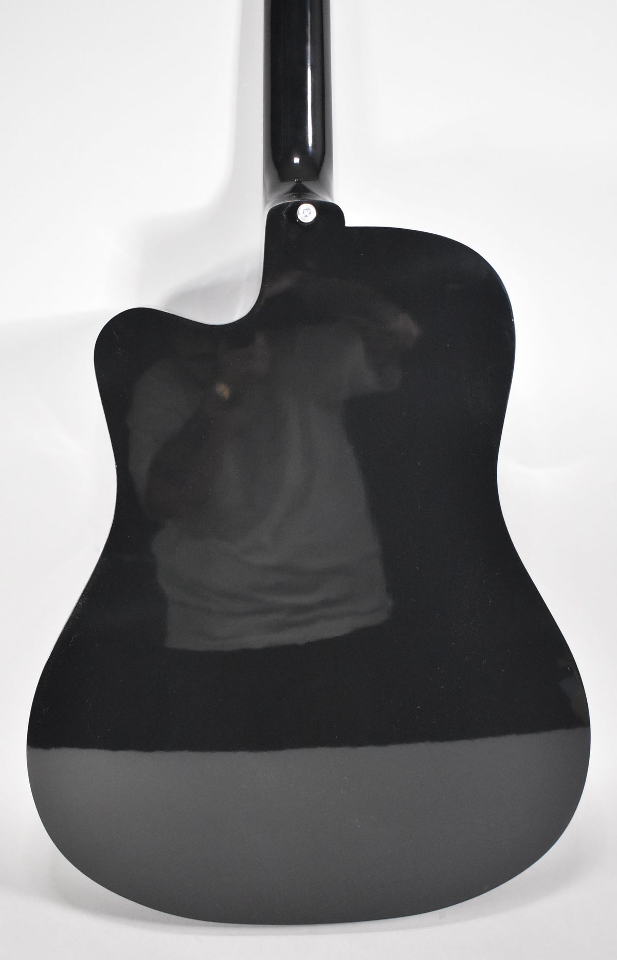 The back of a glossy black acoustic guitar with a cutaway, showing the neck joint and a strap button.