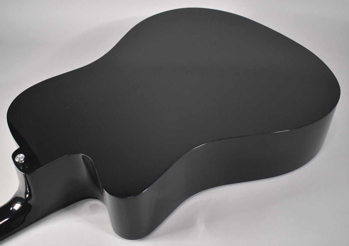The guitar's glossy black body is angled, revealing the back and side with a cutaway near the neck joint.