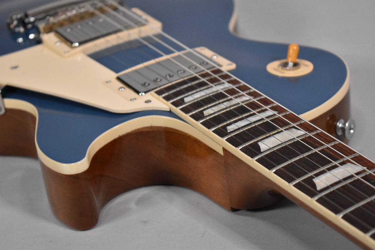 Close-up of the Pelham Blue body and neck joint, showing the cream binding, dark fretboard with trapezoid inlays, and pickup selector.
