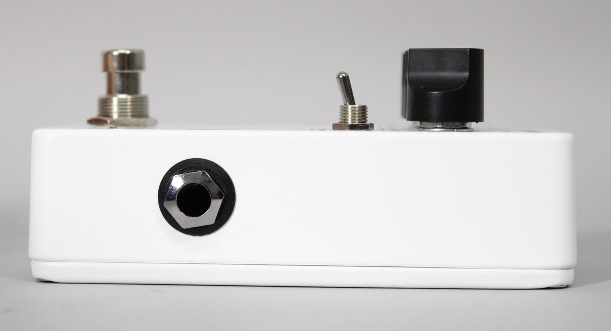 Side view of a white JHS 3 Series Reverb Pedal, showing a chrome footswitch, a toggle switch, a black knob, and an input jack.