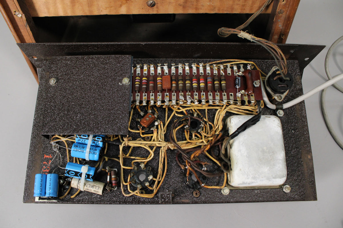 Overhead view of the amplifier's dark brown chassis, revealing a dense network of colorful resistors, capacitors, and wiring.