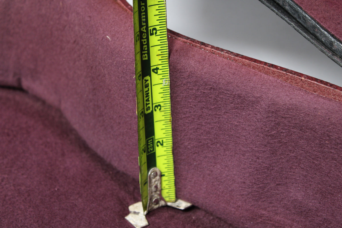 Close-up of the case's burgundy plush interior, with a yellow tape measure showing a depth of approximately 4.5 inches.