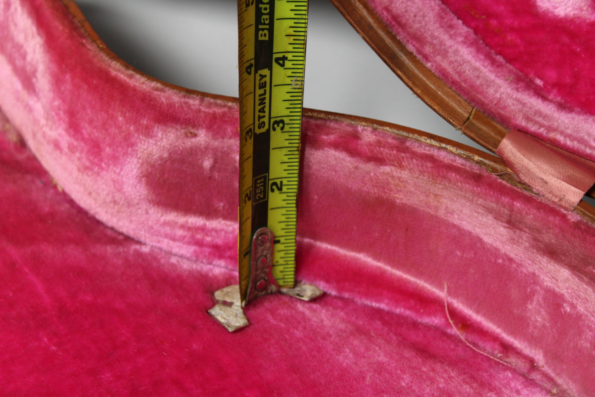 Close-up of the case's worn pink plush lining, with a tape measure showing the interior depth at approximately 2.5 inches.