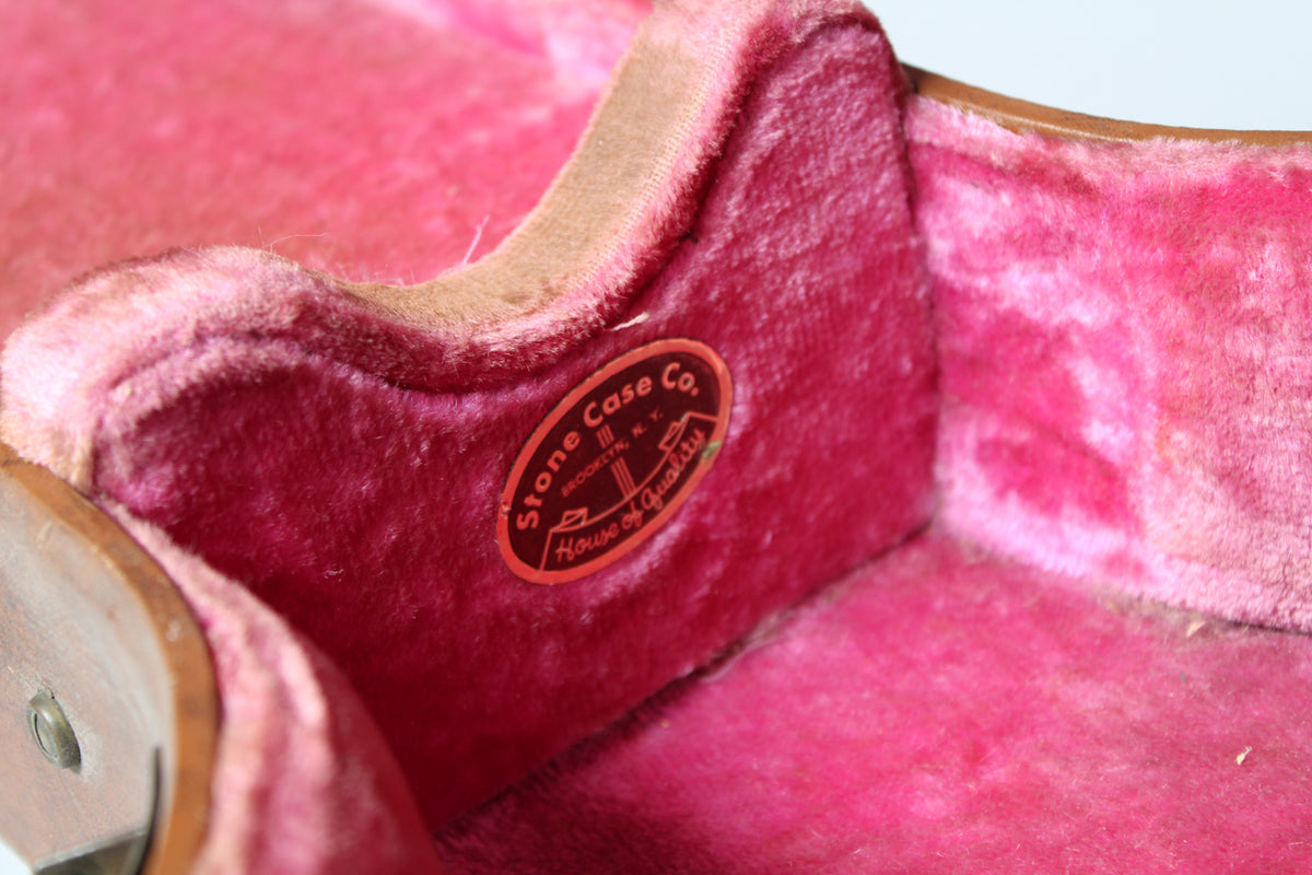 Close-up of the case's interior, showing faded pink plush lining and a red oval "Stone Case Co." label on the neck support.