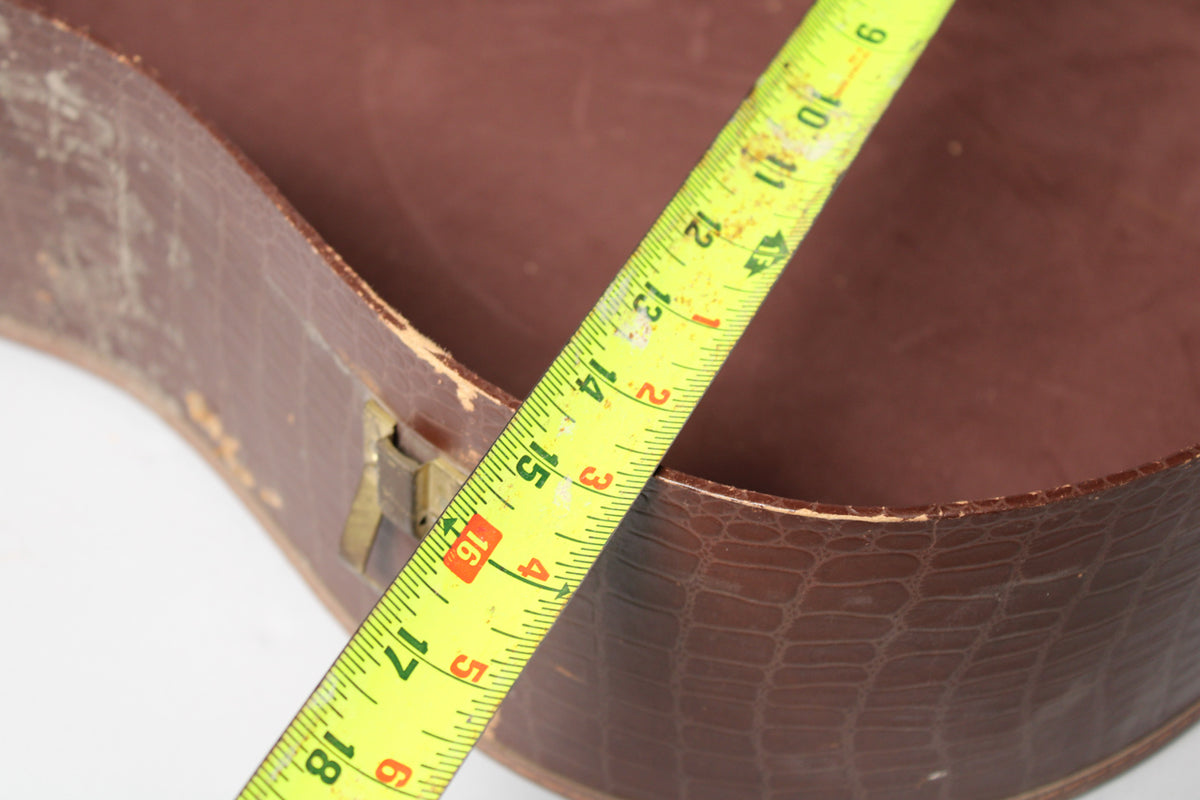 Close-up of the brown alligator-patterned case with a yellow measuring tape showing 9 to 18 inches across the opening.