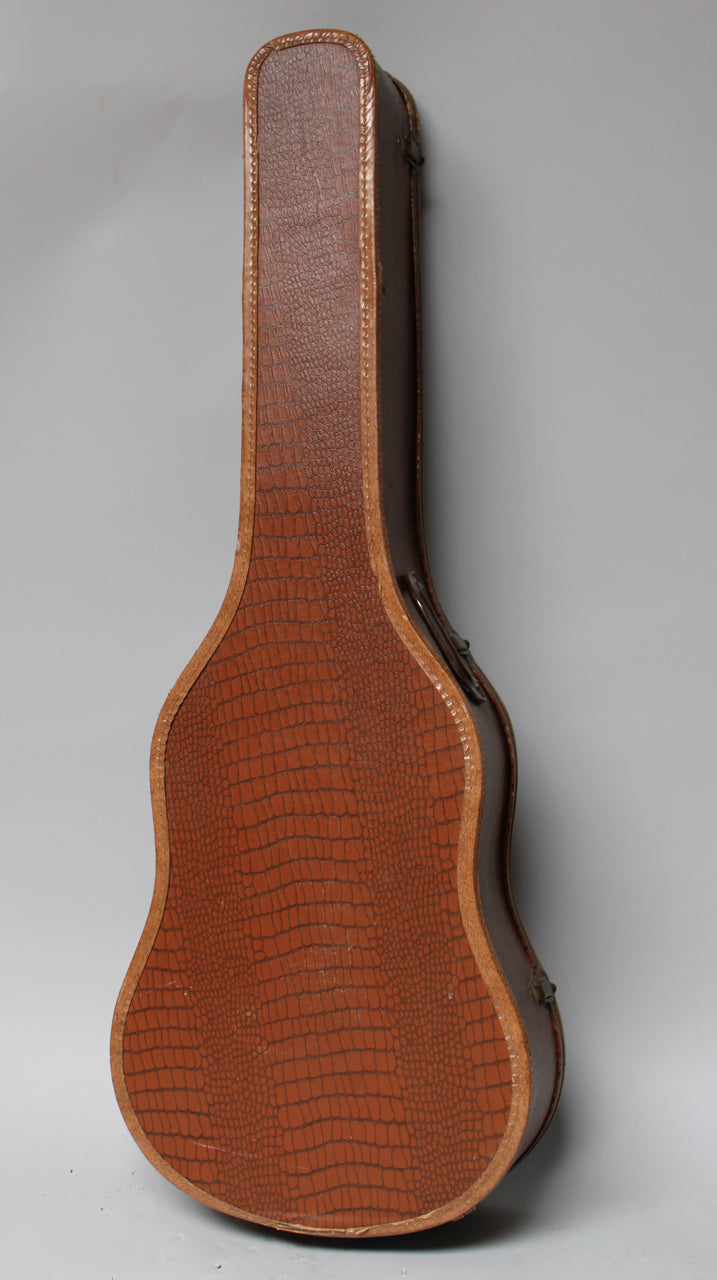 The brown snakeskin-patterned guitar case is shown from the side, revealing its curved shape and a single, worn metal latch.