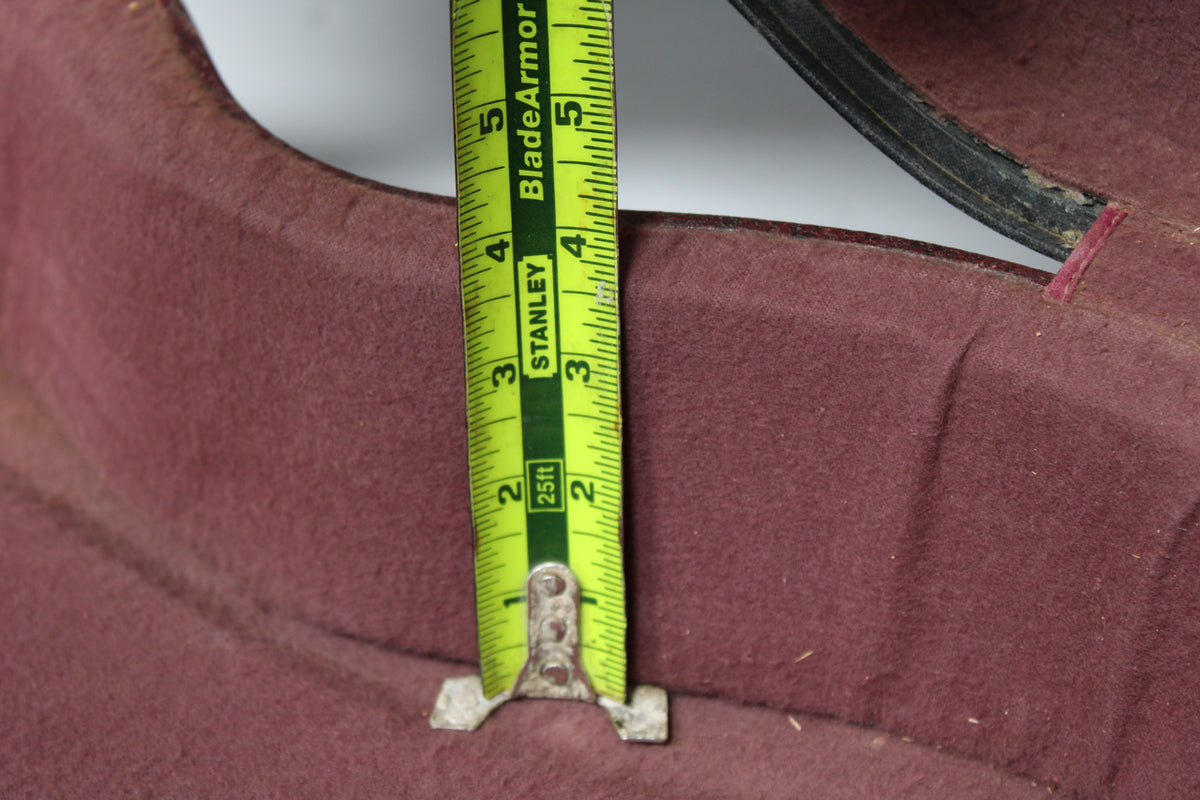 A close-up of the case's burgundy plush interior, showing a tape measure indicating a depth of approximately 4.5 inches.