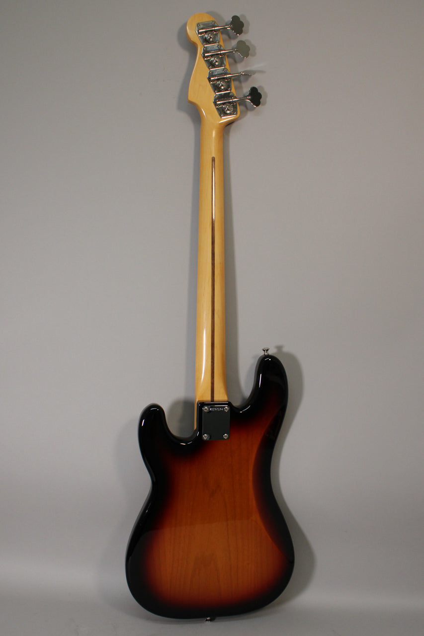 Full rear view of a sunburst bass with a maple neck, chrome tuners, and a visible neck plate.