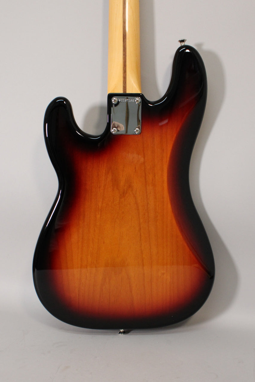 Rear view of a sunburst P-style bass, showing the glossy body, chrome neck plate, and light wood neck with a dark stripe.