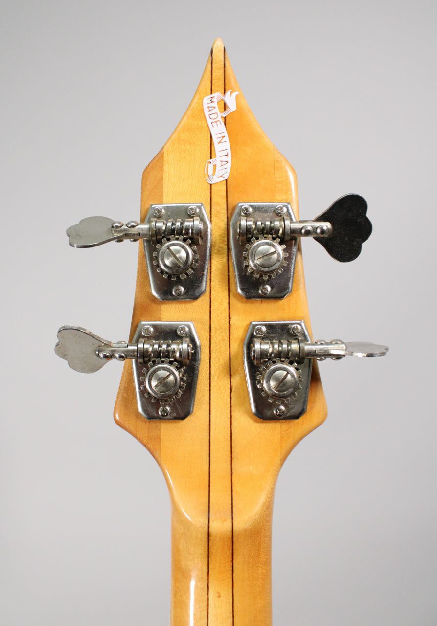 The back of a light wood headstock with four chrome clover-leaf tuners, showing a "MADE IN ITALY" sticker.