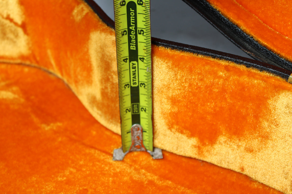 A close-up of the case's orange velvet interior, with a yellow Stanley tape measure showing a depth of 2.5 inches.