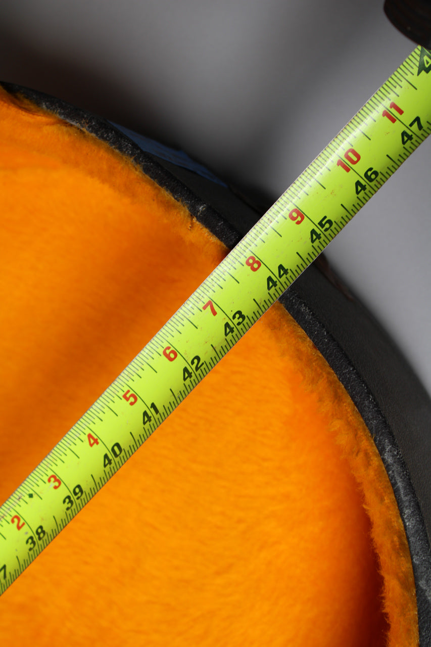 A bright yellow tape measure diagonally spans the black case's orange plush interior, showing measurements from 37 to 47.
