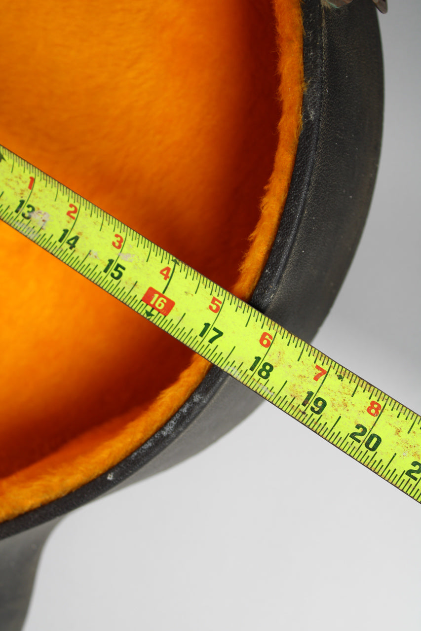 A tape measure spans the orange plush lining of the open black case, showing measurements from 13 to 20 inches.