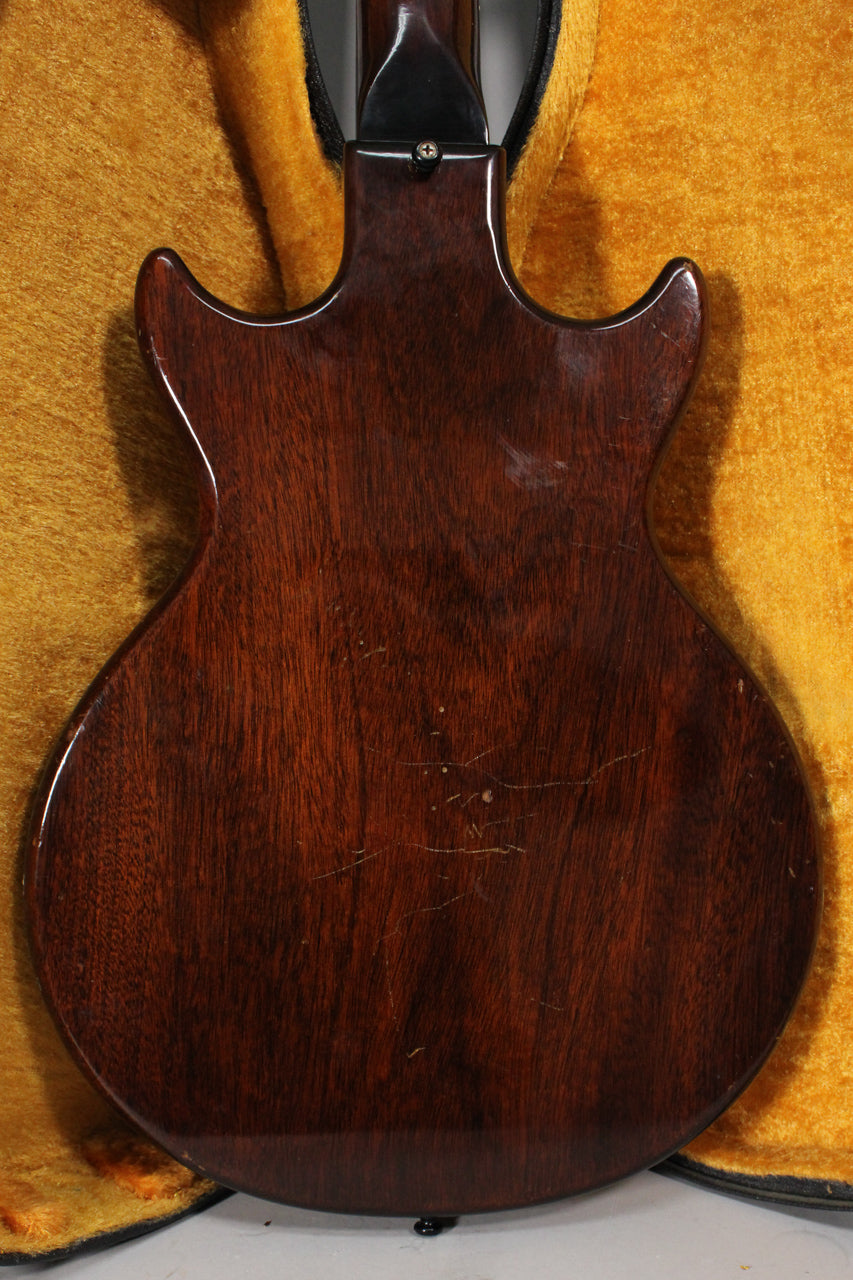 The guitar's dark sunburst back, showing wood grain and finish checking, is visible from the neck joint to the bottom strap button.