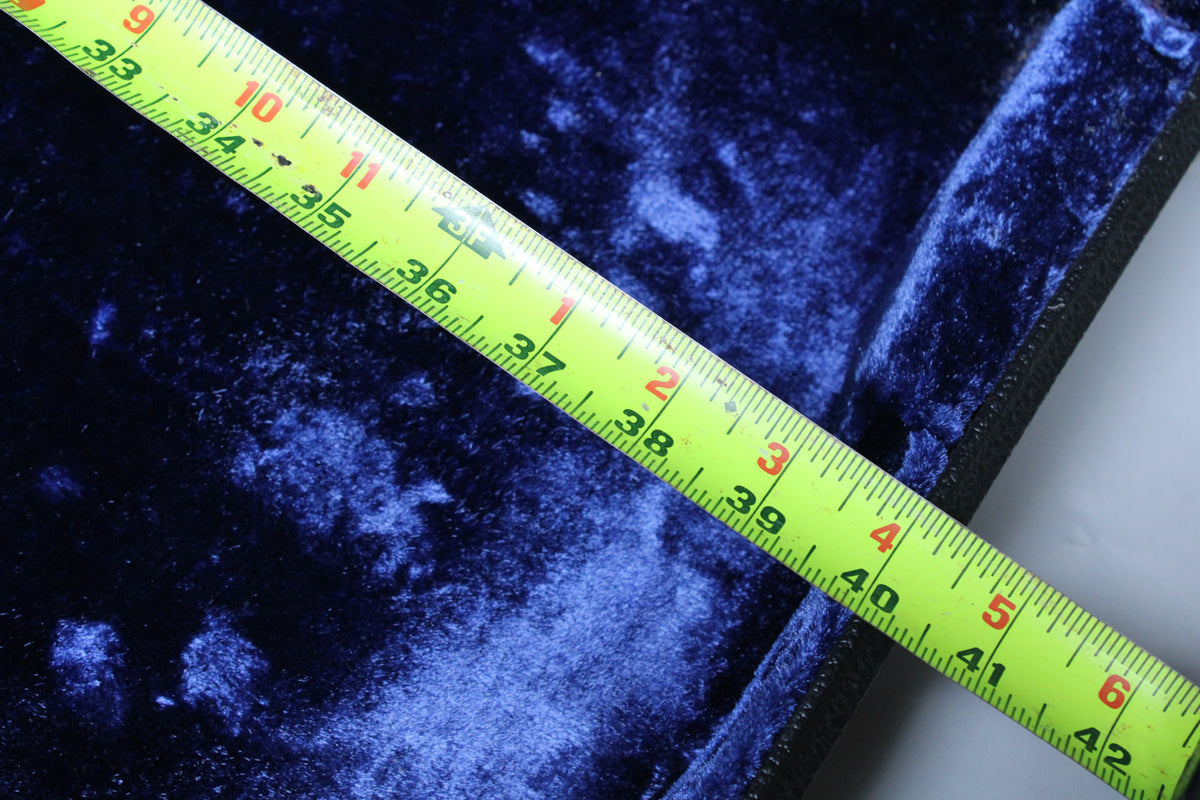 Close-up of the case's dark blue velvet interior, with a yellow measuring tape showing 33 to 42 inches diagonally across.