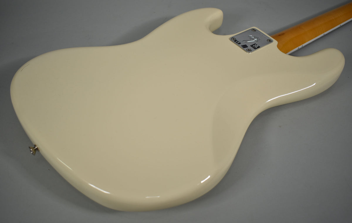 The back of the Olympic White Jazz Bass body is angled, showing a chrome neck plate and a small scuff on the upper horn.